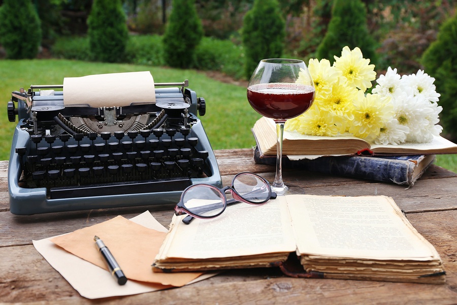 Vintage black typewriter on decorated wooden table, outdoors, cl