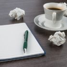 Crumple Paper, Notebook And Pen With Cup Of Coffee