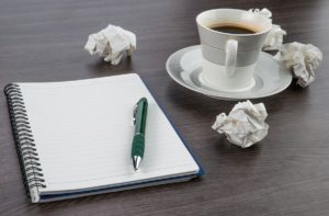 Crumple Paper, Notebook And Pen With Cup Of Coffee